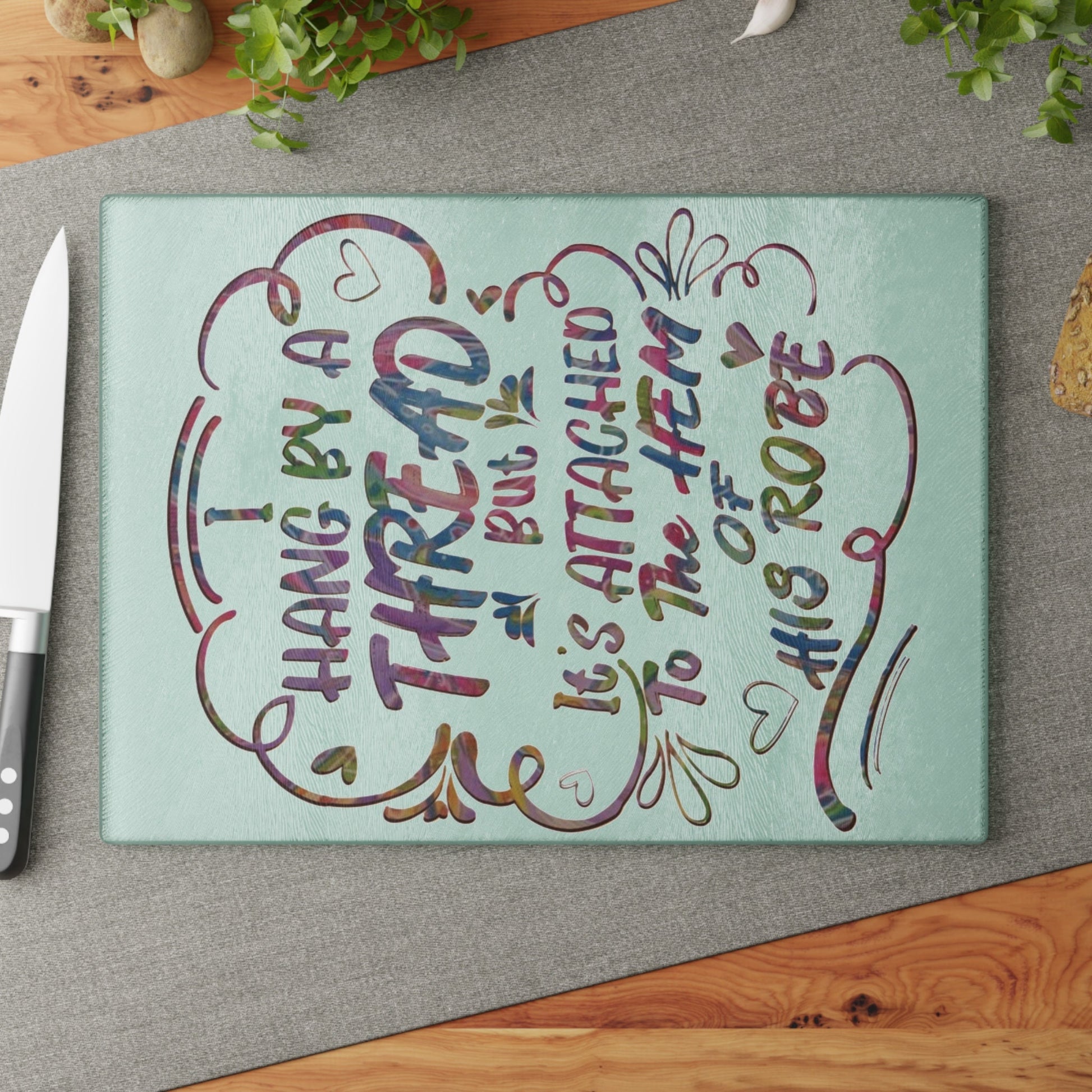 Hanging on to his Robe inspirational Glass Cutting Board